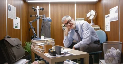 Office worker falling asleep at his desk Stock Footage 309020350