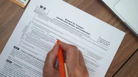 Office worker fills out Request for Taxpayer Identification Number and Stock Footage 283820678