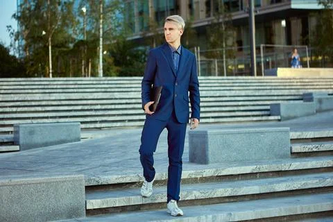 Office worker with folder for papers stands near business center. Stock Photos
