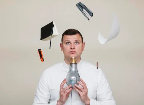 Office worker found an idea for solving a problem, a man with a light bulb Stock Photos