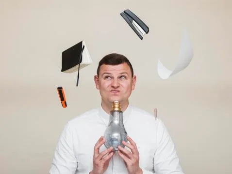 Office worker found an idea for solving a problem, a man with a light bulb Stock Photos