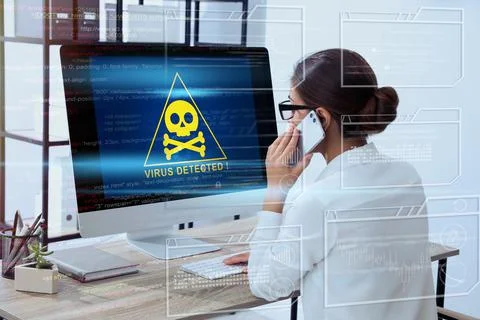 Office worker in front of computer with warning about virus attack on screen 스톡 사진