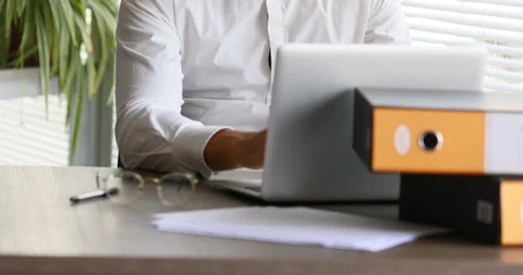 Office worker in front of his laptop writing Stock Footage 89463429