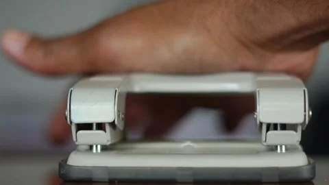 Office worker hand using paper hole puncher Stock Footage 345550038