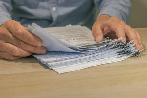 Office worker hands sorting paper documents Stock Photos