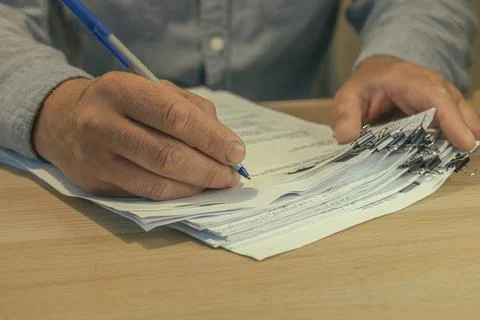 Office worker hands sorting paper documents Stock Photos