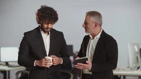 Office worker has problems with a digital tablet and asks for help from a Video stock 258801197