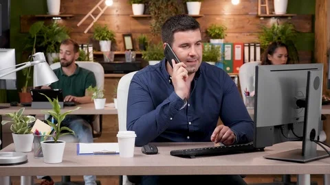 Office worker having a phone conversation in modern and cozy office Stock Footage 112651685