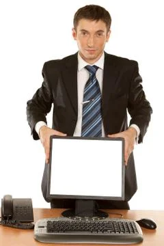 Office worker holding blank computer monitor with clipping path for the scree Stock Photos