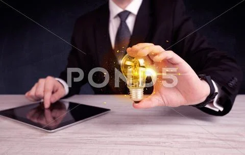 Office worker holding a light bulb Stock Photos