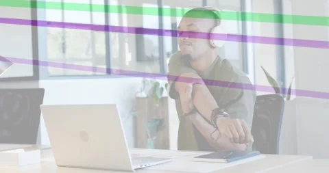 Office worker at laptop glancing wrist checking watch stretching purple or green Stock Footage 333152846