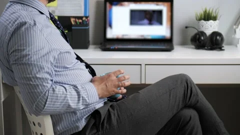 Office worker loafer. Bearded man sitting at workplace in office takes off from Vidéo 130308568