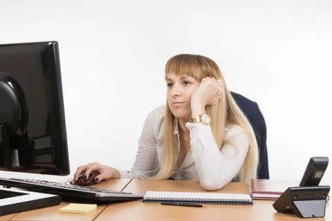 Office worker looking blankly at the computer screen in the office Stock Photos