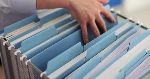 Office worker is looking for document in a file cabinet in office Stock Footage 270458721