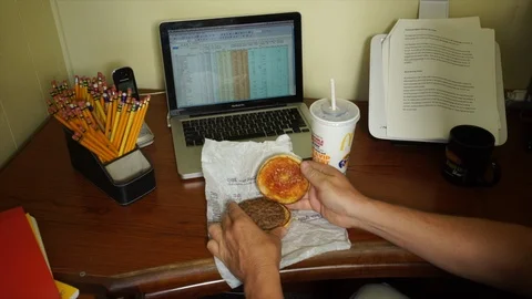Office Worker Looking at Greasy Fast Food Take Out Burger in Disgust Stock Footage 95926913