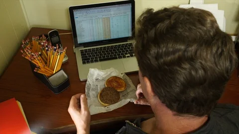 Office Worker Looking at Greasy Fast Food Take Out Burger Stock Footage 95927063