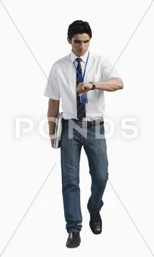 Office worker looking at wristwatch Stock Photos