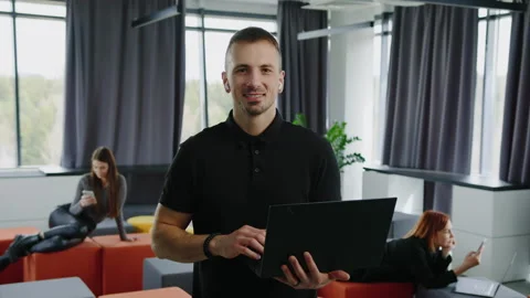 An office worker looks into the camera with a smile. Office Stock Footage 232475144