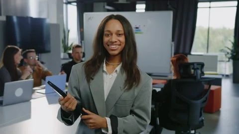 Office worker looks into the camera with a smile Видео 232477040