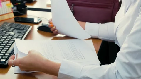 Office worker looks through documents. Preparing documents for the client 動画素材 168779079