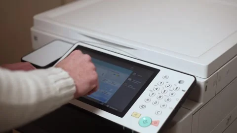 An office worker makes print settings for a printer on a touch screen Stock Footage 294628160