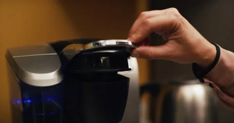 Office worker makes single serve coffee pod in company kitchen. Closeup shot on Stock Footage 199455370
