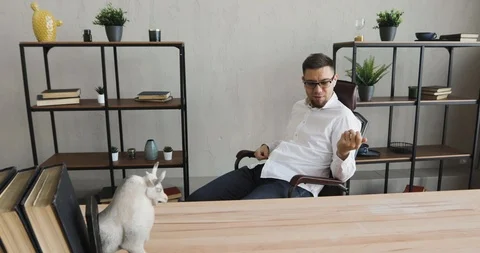 Office worker man dreamer is playing on an imaginary guitar sitting in chair. Stock Footage 120835512