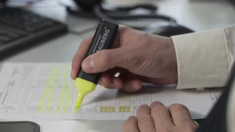 Office worker marks a document with a yellow marker Stock Footage 167252867