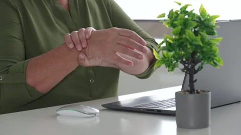 Office worker massaging sore wrist at desk close up Stock Footage 312735948