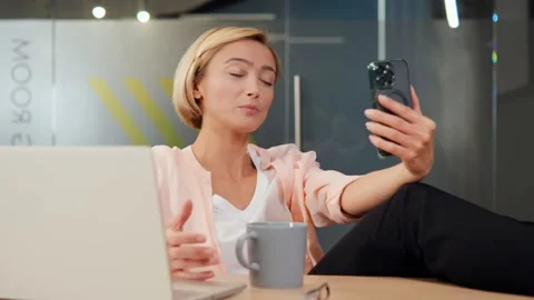 Office worker on mobile video call emphasizes remote teamwork for tech projects. Video stock 237999872