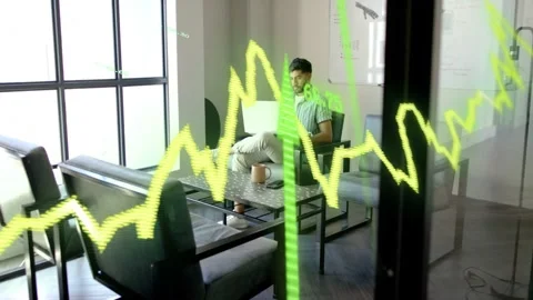 Office worker operating laptop, glancing up as waveform on glass intensifying Stock Footage 333526121
