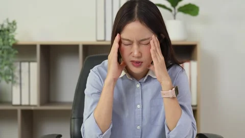 Office worker pauses computer work with head discomfort Stock Footage 348329766