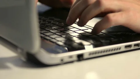 Office worker prints on a laptop beech at a white table. Business man Stock Footage 123602606