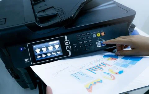 Office worker prints paper on multifunction laser printer. Copy, print, scan, Stock-Fotos