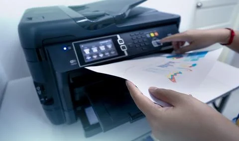Office worker prints paper on multifunction laser printer. Copy, print, sca.. Stock Photos