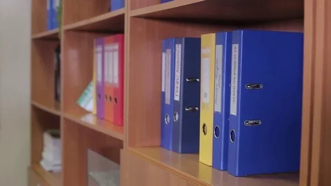 Office worker pulls out a folder Stock Footage 75318273