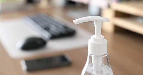 Office worker pumping hand sanitizer gel to prevent virus before working Stock Footage 127014255