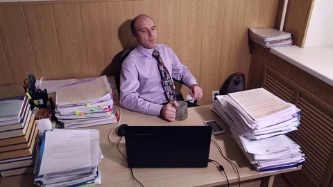 Office worker puts his feet on the table Stock Footage 72691551