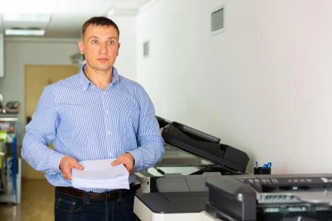 Office worker puts a stack of paper in the printer Foto stock