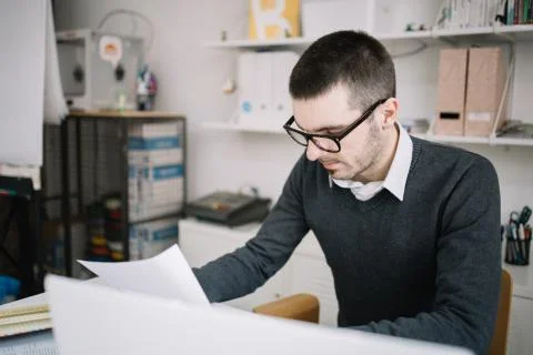 Office worker reading paperwork in the office Foto stock
