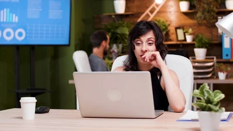 Office worker reads some good news on the laptop Stock Footage 111513564