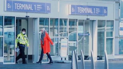 An office worker in red clothes and a medical mask enters the station terminal. Stock Footage 126610196