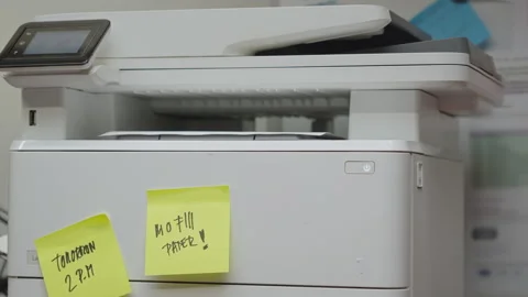Office Worker Removes Printed Papers from Printer with Reminder Notes Видео 338171701