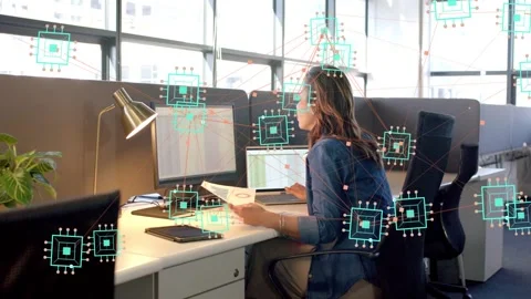 Office worker reviewing paper, verifying data on monitors while AI overlay Stock Footage 333034900