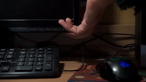 Office worker routine. Cropped shot of man switching computer monitor on. Wires Stock Footage 118233779
