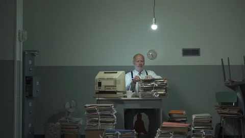 Office worker searching for files in a messy office 動画素材 118082789