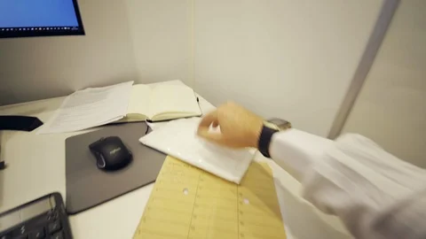 Office worker searching for papers at desk, checking phone. Shot POV, 4K Stock Footage 113832317