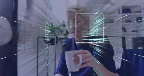Office worker sipping white mug and returning gaze, causing HUD code converging Stock Footage 334114058