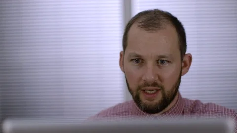 An office worker sits down and sees something good on his laptop Stock Footage 73124088
