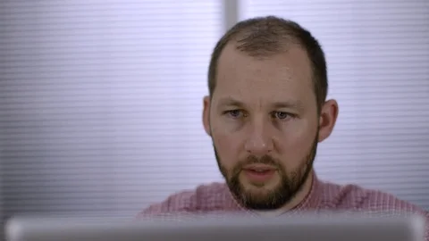 An office worker sits down at his desk to begin work at laptop computer. Stock-Footage 73124097